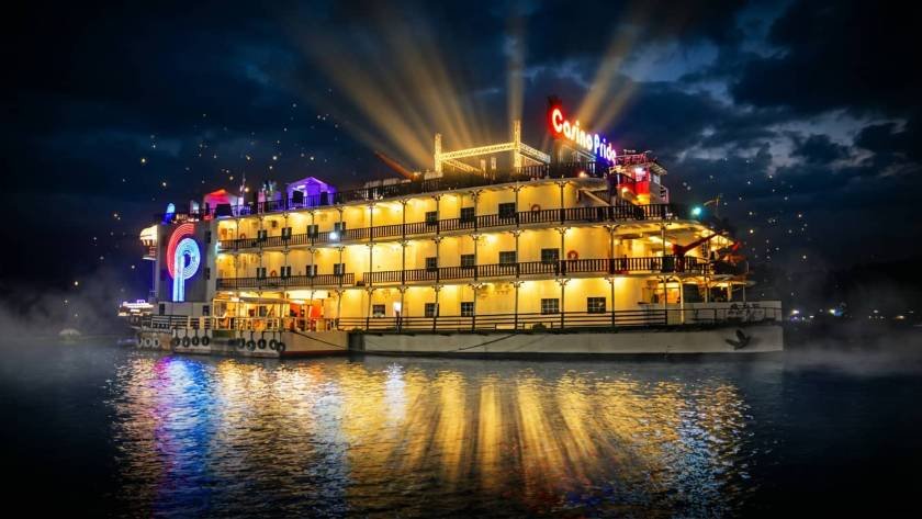 Casino Pride floating casino in Goa glowing at night on Mandovi River with golden lights reflecting on water