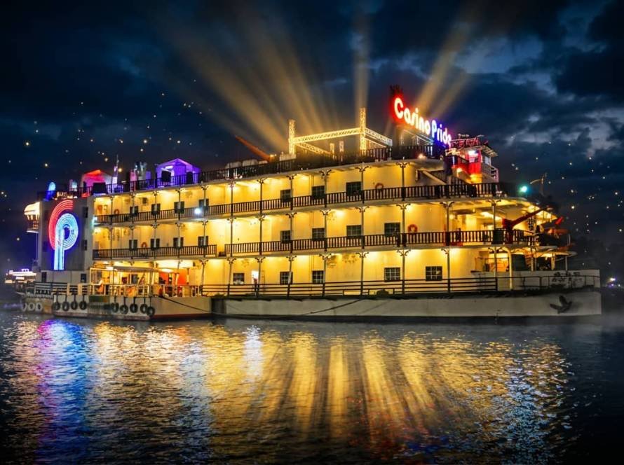Casino Pride floating casino in Goa glowing at night on Mandovi River with golden lights reflecting on water